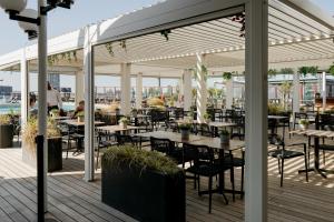 a patio with tables and chairs on a deck at ss Rotterdam by WestCord in Rotterdam
