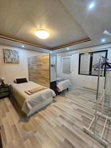 a bedroom with a bed and a wooden floor at House for 4 person near Meyer Turku in Turku