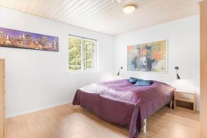 a bedroom with a bed in a white room at 945-Frederiksvaerk-Soltoften-3 in Frederiksværk