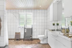 a white bathroom with a toilet and a sink at 945-Frederiksvaerk-Soltoften-3 in Frederiksværk +25 photos