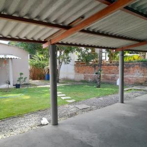 an empty patio with awning in a yard at Casa em Itaúnas para temporada e carnaval in Itaúnas