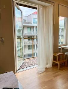 a room with a large window with a view of a building at Modern lägenhet i Vasastan in Stockholm
