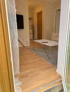 a view of a living room with a table and a room at Modern lägenhet i Vasastan in Stockholm +1 photo
