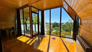 a room with large windows and a wooden floor at Alamabari Inn in Kobuleti