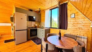 a kitchen and dining room with a table and chairs at Alamabari Inn in Kobuleti