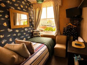 a small bedroom with a bed and a window at The Ocean Guest House in Weymouth