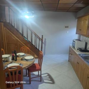 a kitchen with a table with chairs and a microwave at The Relic in Olympos +6 photos