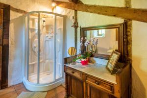 a bathroom with a shower and a vanity with a mirror at Maison De Charme Avec Jacuzzi in Arcangues