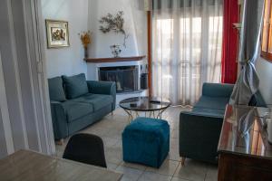 a living room with a couch and a table at Zoli house in Pefkochori