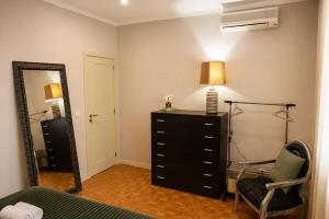 a bedroom with a dresser and a mirror at Casa do Alto Vila Caiz in Amarante