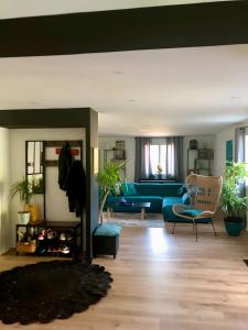 a living room with a blue couch and a fireplace at Villa Stella in Montauban