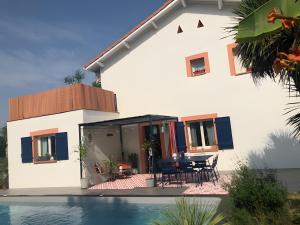 a house with a pool in front of it at Villa Stella in Montauban