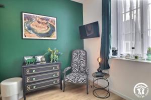 a room with a dresser and a chair and a dresser at Le rok in Billé