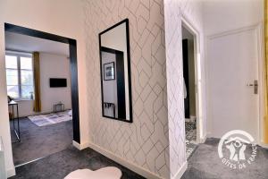 a hallway with a mirror on a wall at Le rok in Billé +43 photos