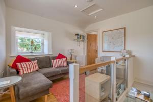 a living room with a couch and a table at Hafod in Tenby