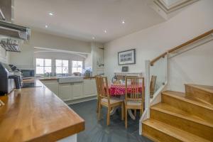 a kitchen and dining room with a table and chairs at Hafod in Tenby +34 photos
