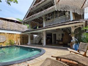 a villa with a swimming pool and a house at Villa Asmara Gili Air in Gili Islands