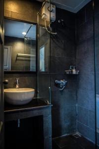 a bathroom with a sink and a glass shower at JamPark City in Bangkok