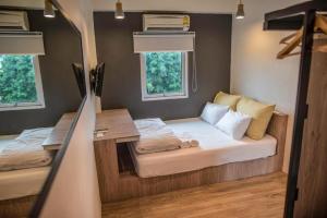 a small room with a bed and a desk at JamPark City in Bangkok