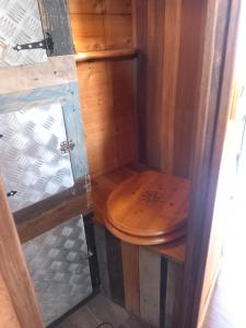 a bathroom with a wooden toilet in a room at Campertruck Off-Grid in Hénon