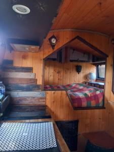 a room with a bed and stairs in a cabin at Campertruck Off-Grid in Hénon