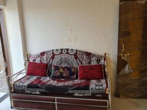 a couch with pillows on it in a room at Umahomestay in Nashik