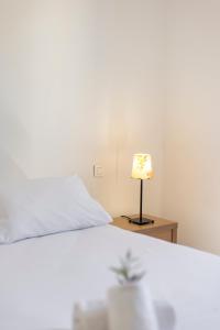 a bedroom with a bed and a lamp on a table at Casa Mia in Porto-Vecchio
