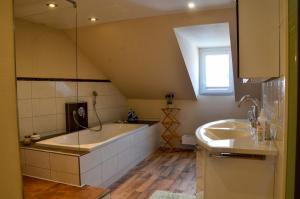 a bathroom with a large tub and a sink at Ferienwohnung NORA - direkt am Bodensee in Friedrichshafen +47 photos