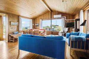 a living room with blue couches and a table at FY269-Faaborg-Lille-Stege-2 in Faaborg