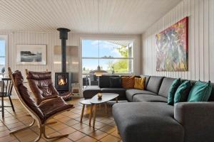 a living room with a couch and a fireplace at 8124-Ronde-Rytterparken-33 in Rønde