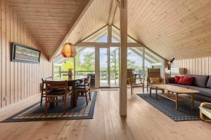 a living room with a table and a couch at 8923-Allingabro-Poppelvej-17 in Allingåbro