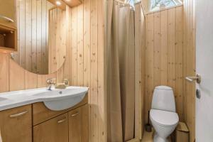 a bathroom with a sink and a toilet and a mirror at 8923-Allingabro-Poppelvej-17 in Allingåbro +23 photos