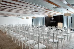 a row of chairs in a room with a stage at Veridia Resort Sardinia, a member of Radisson Individuals in Chia +105 photos