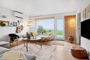a living room with a couch and a table in a room at 30116-Odder-P-Baatrupsvej-47 in Odder