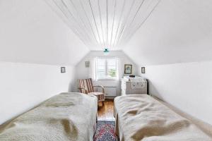 a bedroom with two beds in a room with a window at 1102-N-Hundested-Skansevej-45 in Hundested