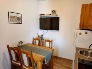 a small kitchen with a table and a refrigerator at Apartment Lore in Primošten