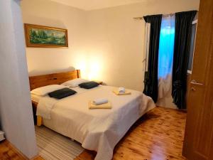 a bedroom with a bed with two towels on it at Apartment Lore in Primošten