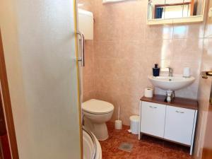 a bathroom with a toilet and a sink at Apartment Lore in Primošten +28 photos