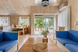 a living room with blue couches and a table at 588-N-Hundested-Krusemyntestien-5 in Hundested