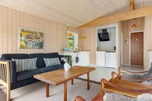 a living room with a couch and a table at 588-N-Hundested-Krusemyntestien-5 in Hundested