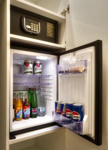 an open refrigerator filled with drinks and soda at Golden Star in Prague