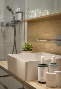 a white bathroom sink with two bottles on a counter at Golden Star in Prague
