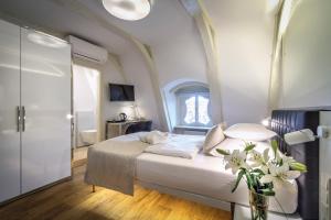 a bedroom with a bed with a vase of flowers at Golden Star in Prague