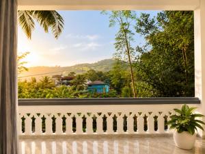 a window with a view of the mountains at Chooravelil Villa, Adimali - Family Stay Near Munnar in Anniyartholu +15 photos