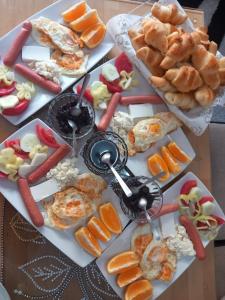 a table filled with different types of food on plates at Apartment with two bedrooms in Glogošnica +24 photos