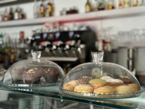 two glass trays of pastries sitting on a counter at Residenza Dottavio in Montenero di Bisaccia