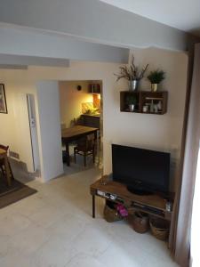 a living room with a television and a table at Village house 8 beds in Joncels