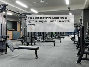 a gym with a sign that says free access to the max fitness gym in pineapple at Numa Prague Republika in Prague