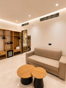 a living room with a couch and a table at The Wine Suites in Rhodes Town