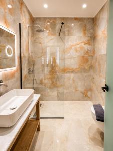 a bathroom with a sink and a shower at The Wine Suites in Rhodes Town